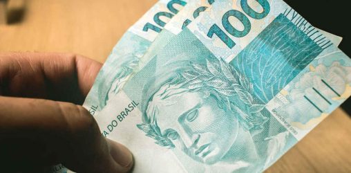 3 notas de 100 reais, representando um empréstimo de 300 reais